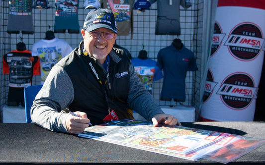 John signing his 2021 Motul Petit Le Mans posters at Michelin Raceway Road Atlanta.